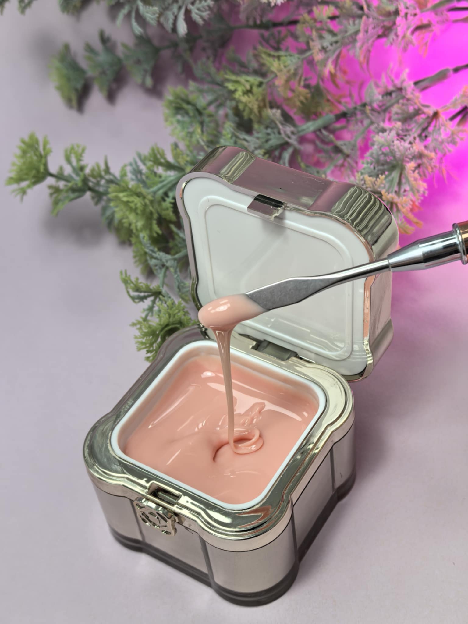 Lemmy Builder Gel 13 - Peach Nectar in an open jar with applicator, showcasing creamy texture against purple and green floral background.